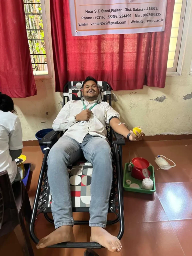 Student donating blood during Blood Donation Camp 2025 at PES College of Pharmacy Phaltan