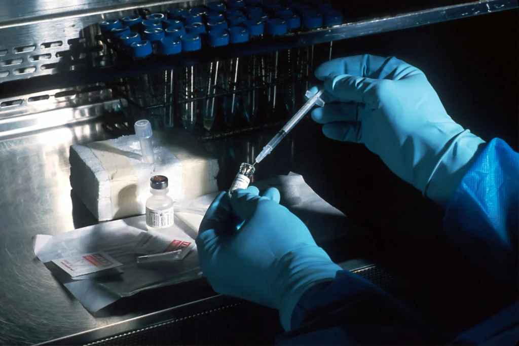 Scientist working with analytical instruments in a pharmaceutical quality control laboratory